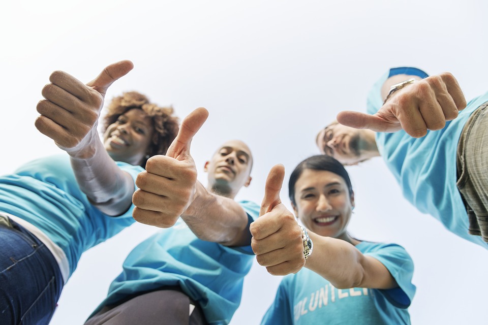 A group of professional movers showing thumbs up for hiring professional assistance when moving